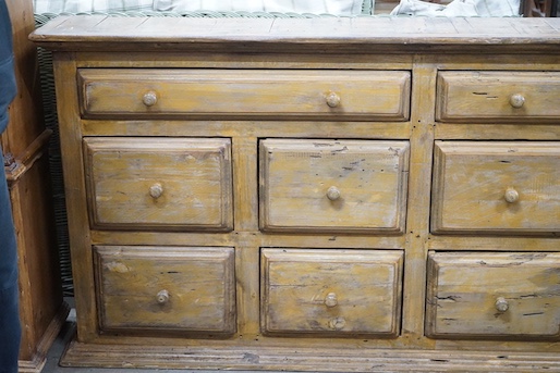 A 19th century style provincial bank of ten painted pine drawers, width 179cm, depth 26cm, height 85cm